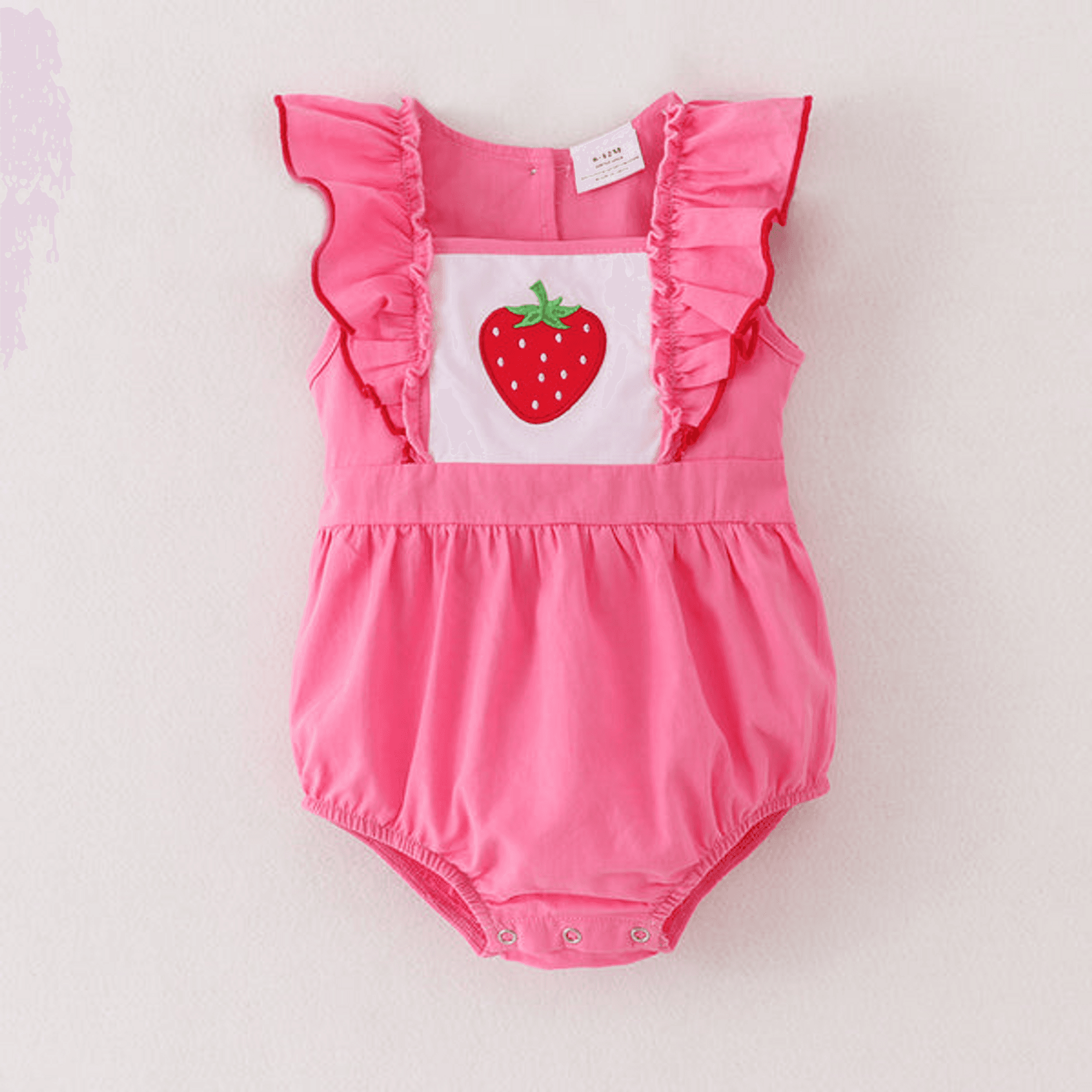 Pink strawberry applique ruffle romper with cap sleeves and snap button legs