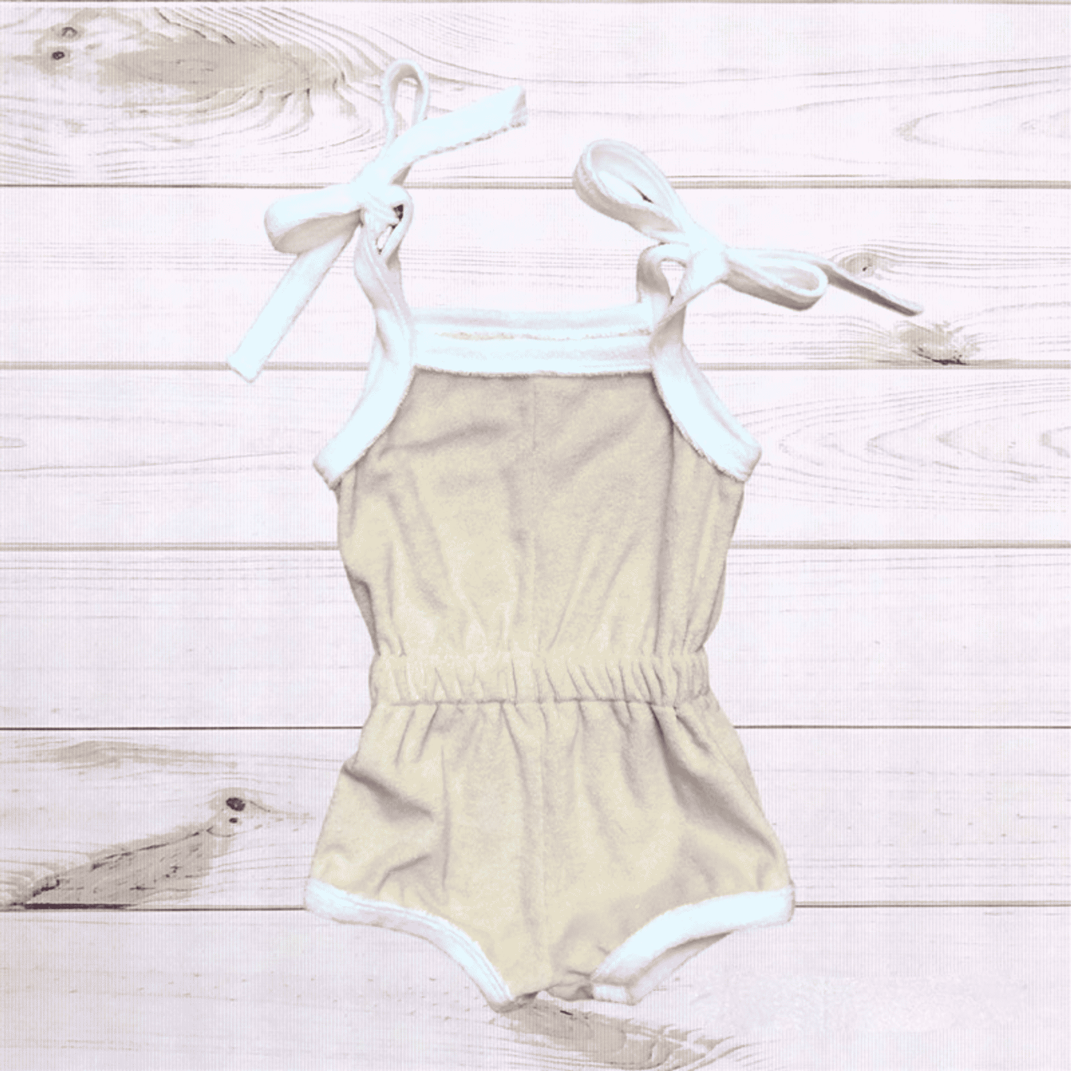 Natural terry cloth romper, light tan with bow-tie straps and short romper legs