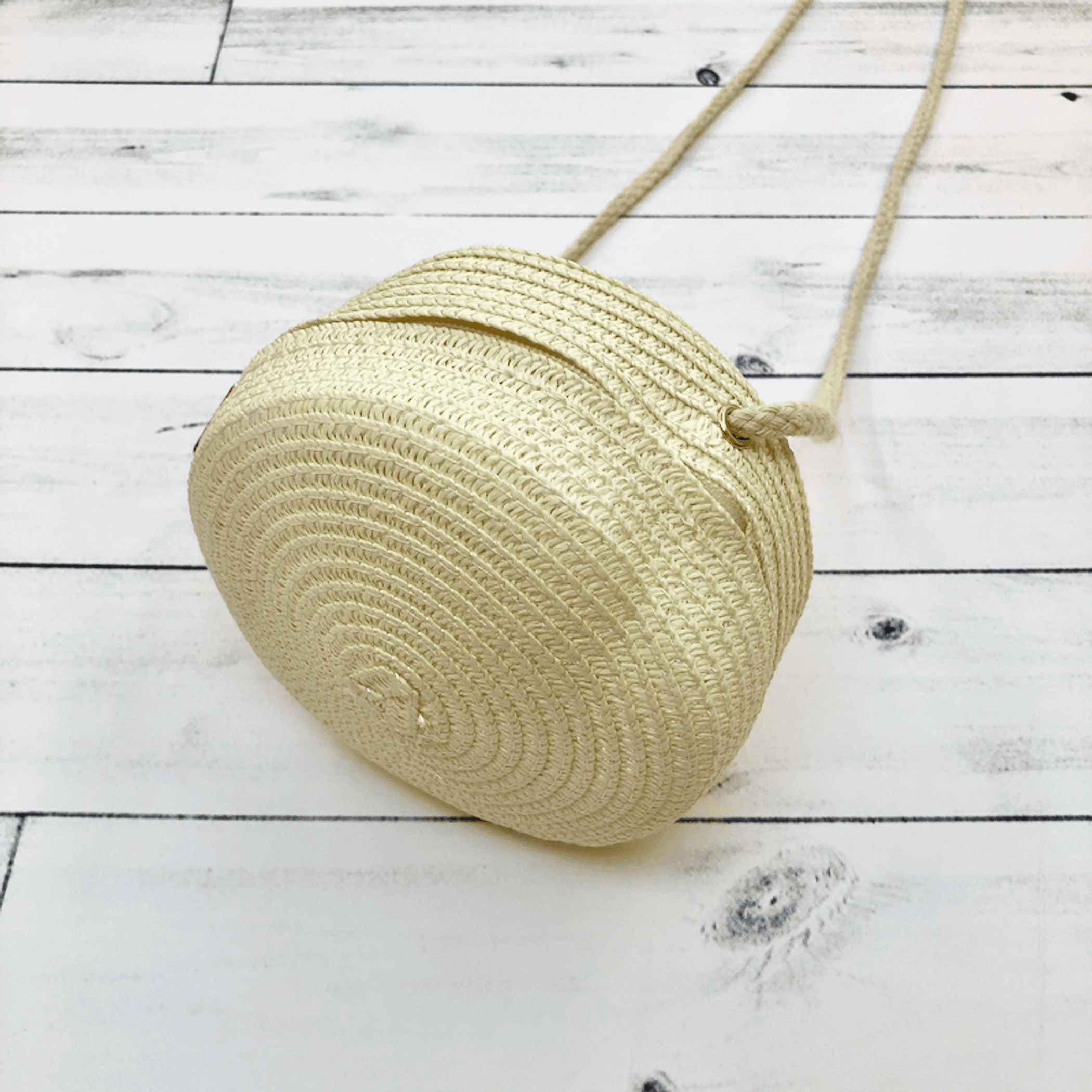 Beige woven round purse with short strap and button closure