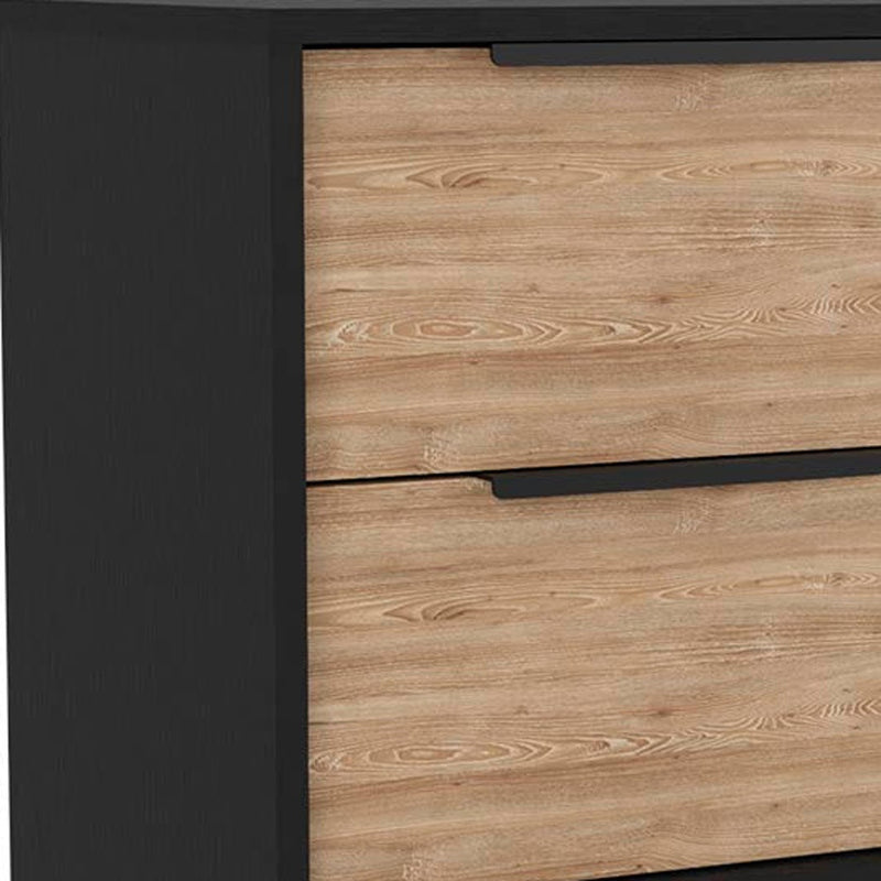 Brown wood-finish drawer fronts on a black dresser with recessed handle