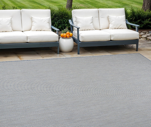 Blue and ivory indoor/outdoor area rug with small diamond lattice pattern