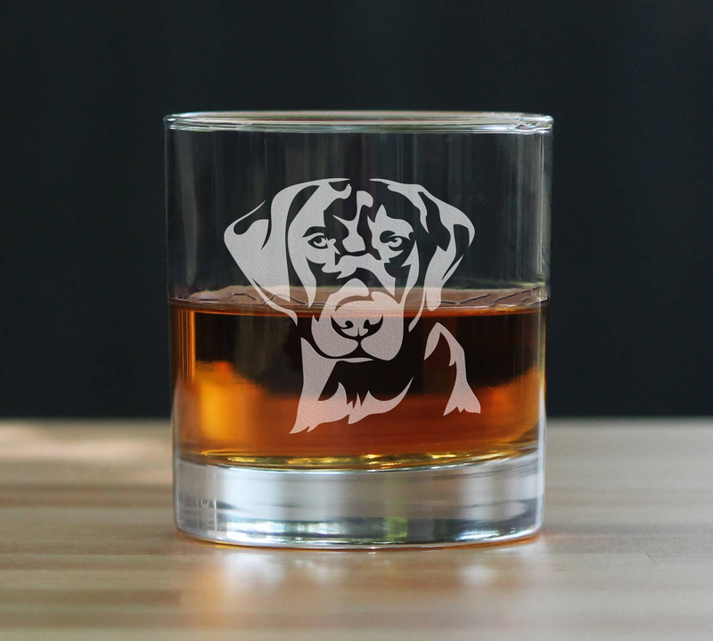 Clear whiskey rocks glass with bold black lab face graphic and amber fill