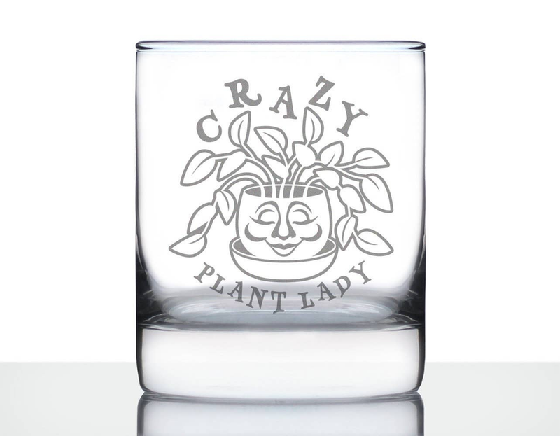 Clear whiskey rocks glass with etched Crazy Plant Lady plant-face and text.