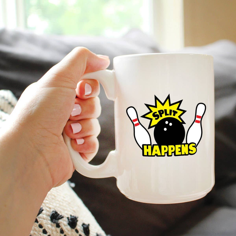 White ceramic mug with bowling pins and "Split Happens" print, held in a hand