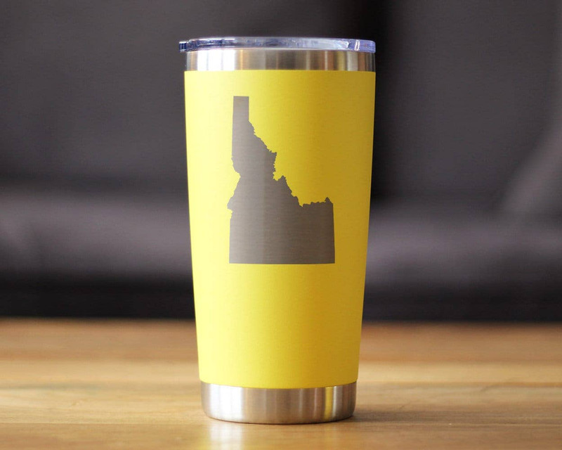 Yellow insulated travel tumbler with etched Idaho silhouette and stainless steel bottom