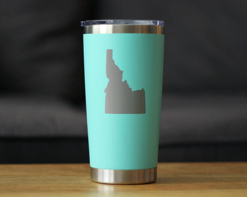 Teal insulated travel tumbler with etched Idaho silhouette and stainless steel base