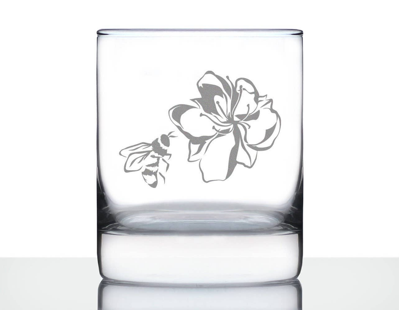 Clear whiskey rocks glass with etched flower and bee design