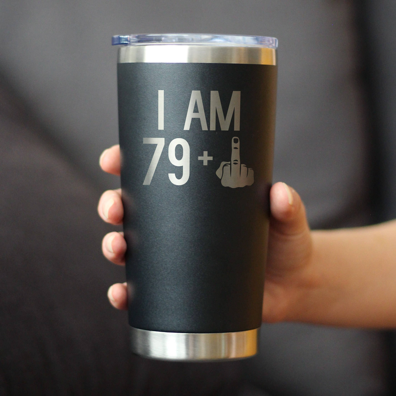 Black insulated travel tumbler held in hand, 'I AM 79+' design