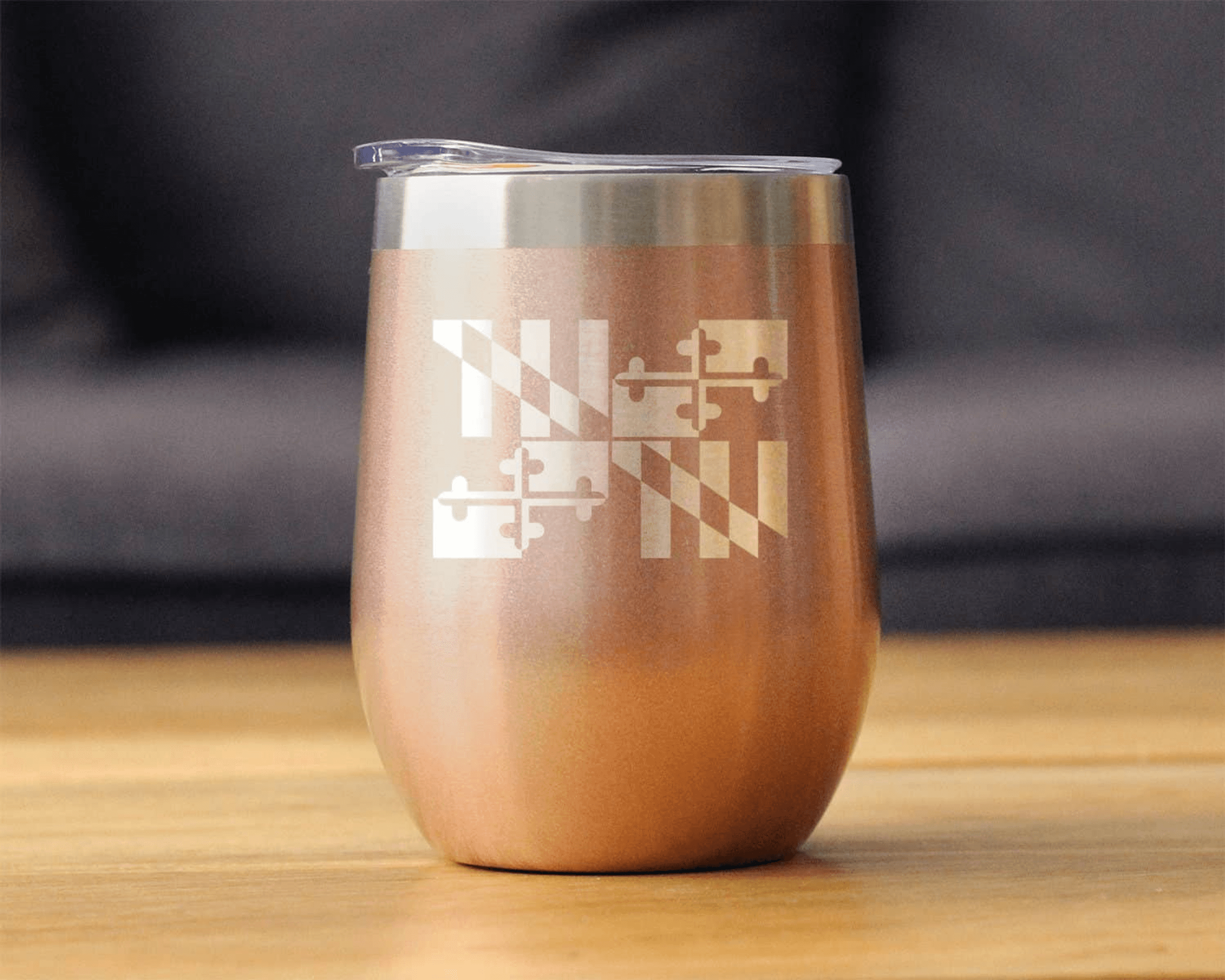 Rose gold insulated wine tumbler with etched Maryland emblem and stainless steel lid