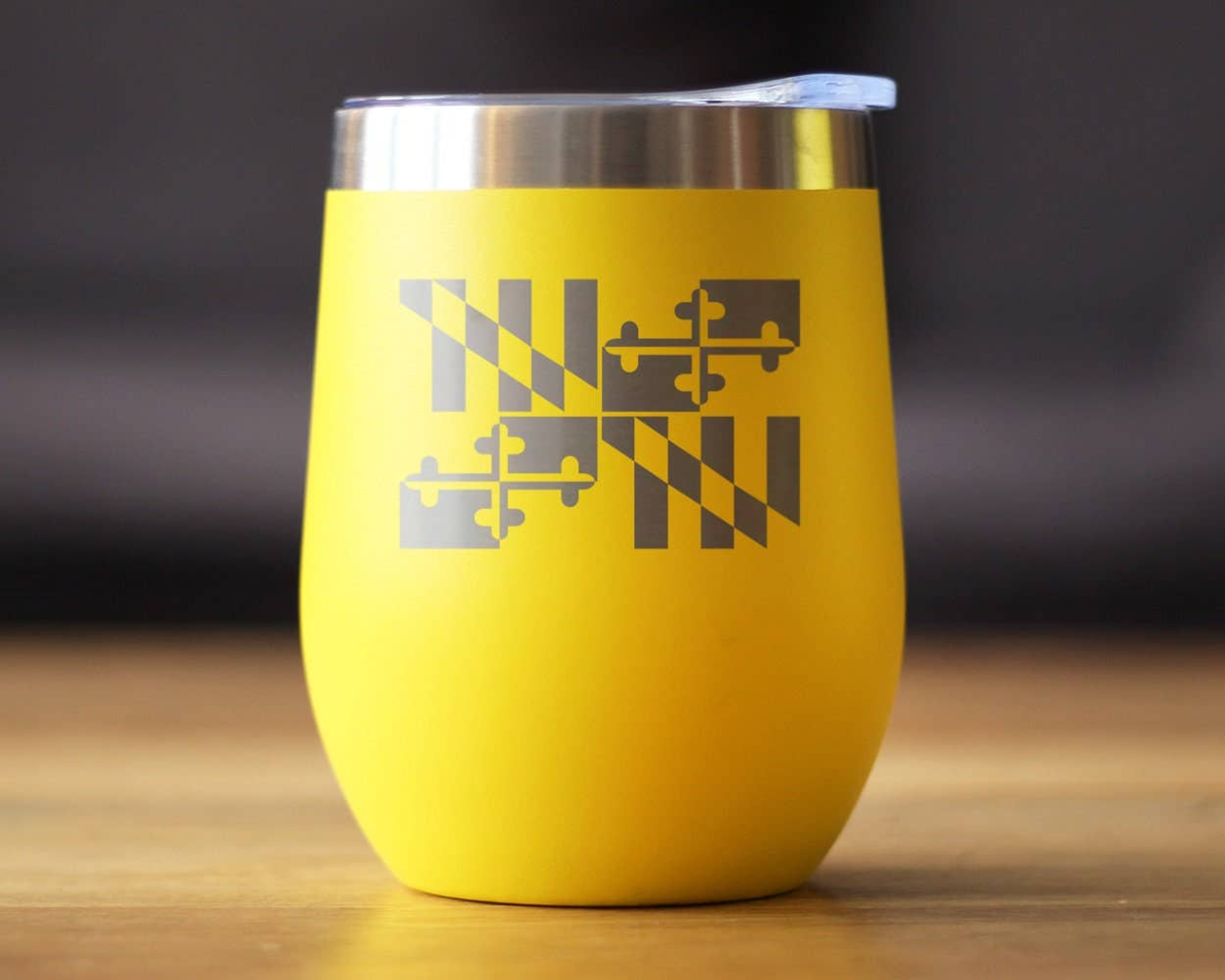 Yellow insulated wine tumbler with etched Maryland emblem and stainless steel lid