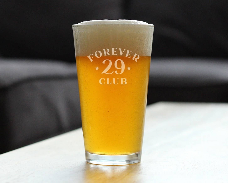 Clear pint glass filled with amber beer, 'FOREVER 29 CLUB' etched