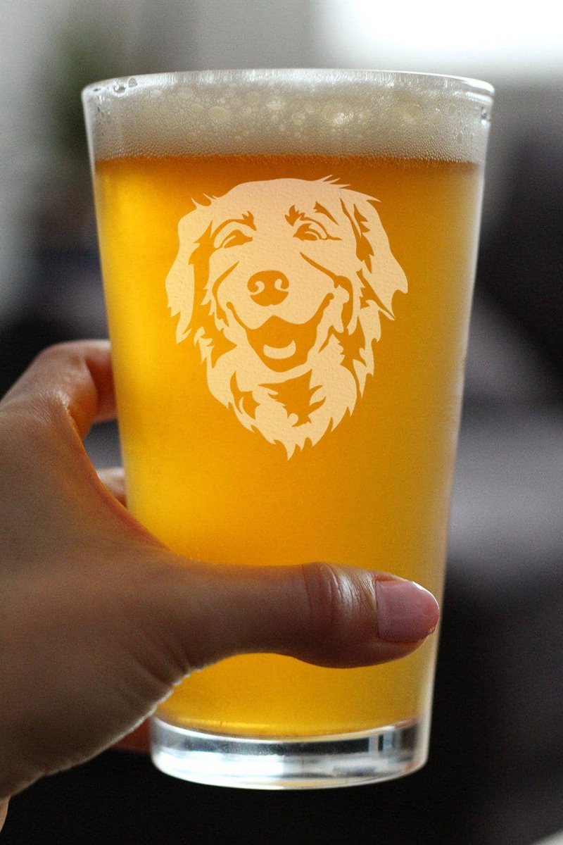 Pint glass of amber beer with etched golden retriever face