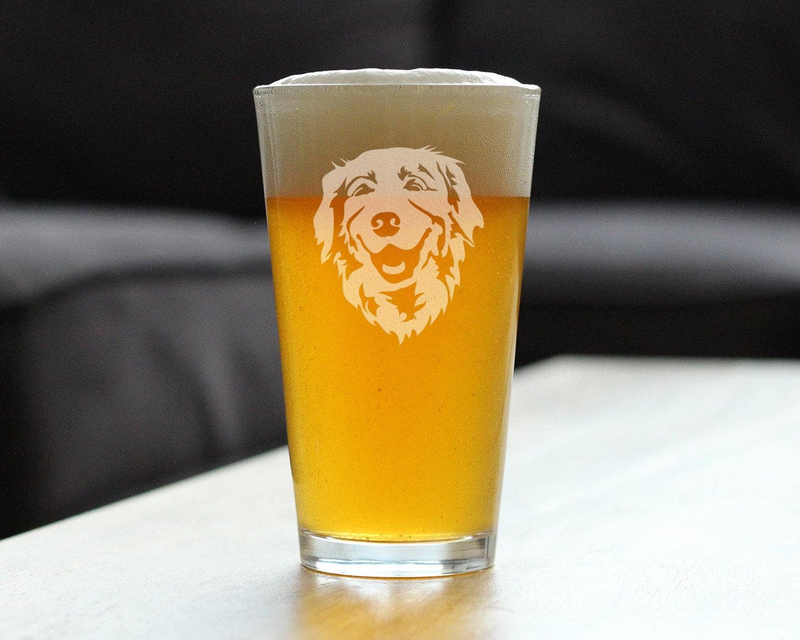 Pint glass with amber beer and etched golden retriever face