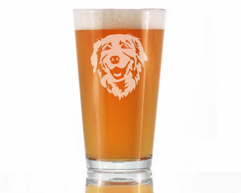 Pint glass of orange beer with etched golden retriever face and foam top