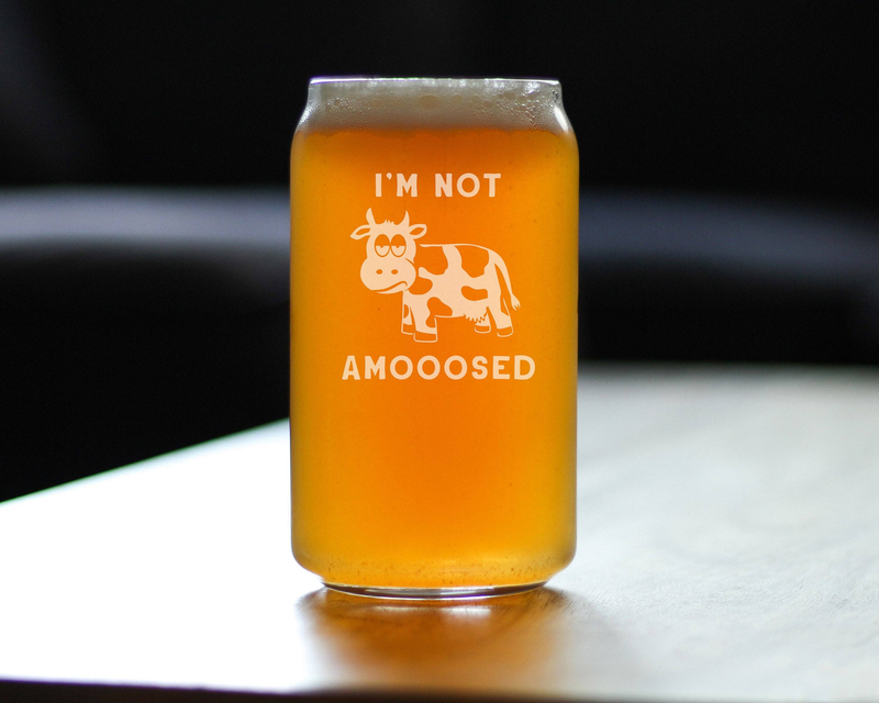 Beer can pint glass with etched cow and “I’M NOT AMOOOSED”, filled with amber beer