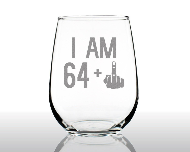 Clear stemless wine glass with etched "I AM 64" and middle finger graphic