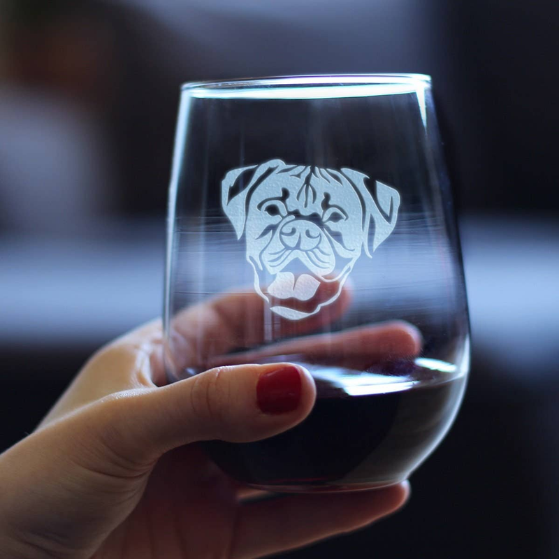 Hand holding a stemless wine glass with an etched boxer dog face