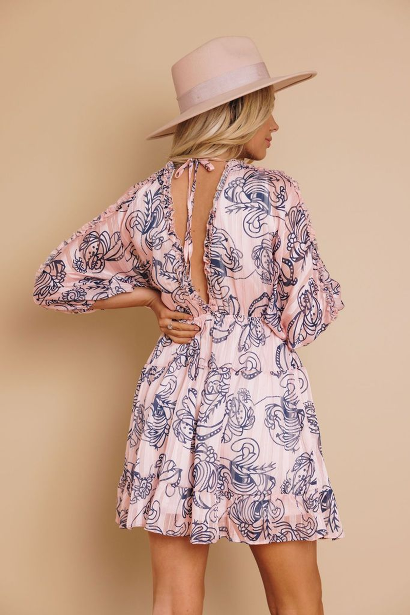 Pink babydoll mini dress, navy line-art print; open back with tie bow, puff sleeves