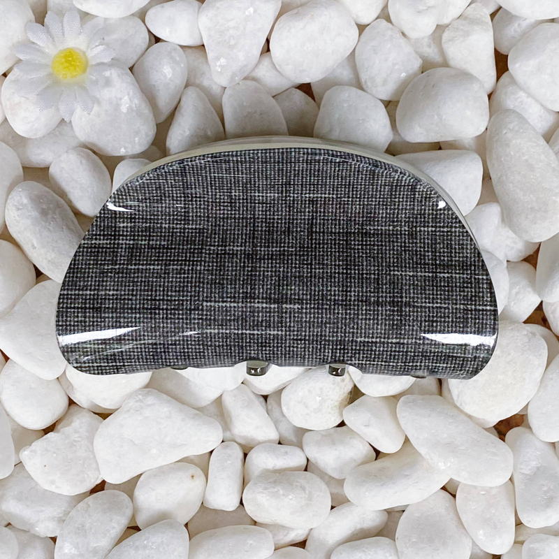 Dark gray textured hair claw clip with three metal prongs