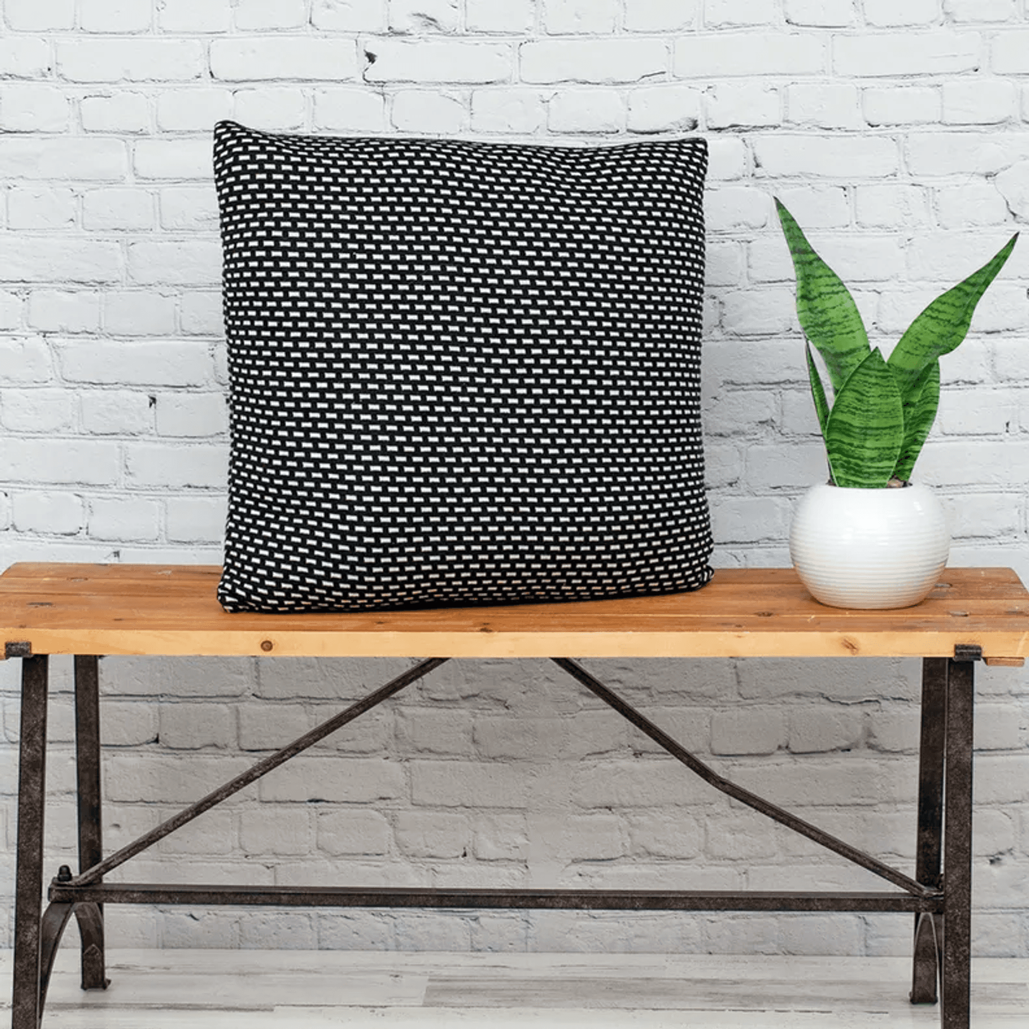 Black and white woven square throw pillow with tight grid pattern