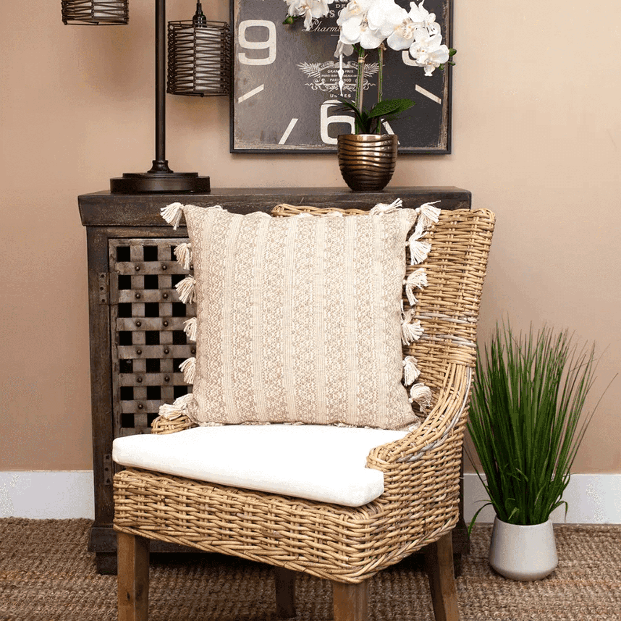 Square beige throw pillow with embroidered stripe texture and fringe tassel edges.