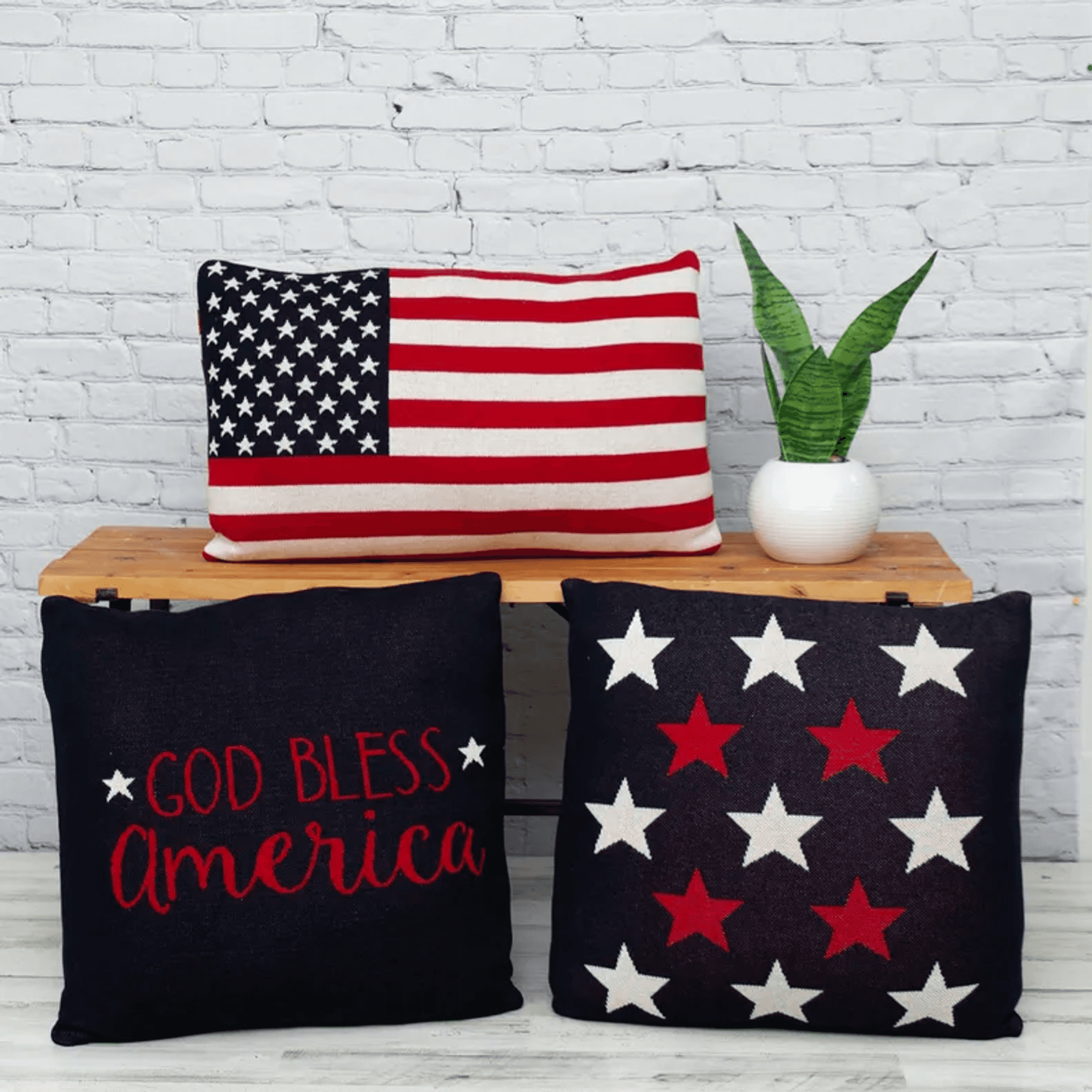 Navy throw pillows: one “God Bless America” text, one with red-and-white star pattern