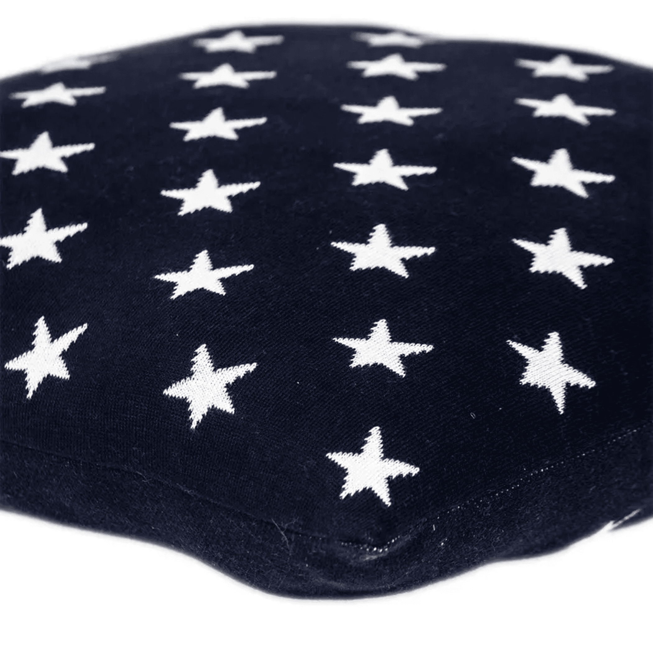 Navy throw pillow corner with white stars on textured fabric