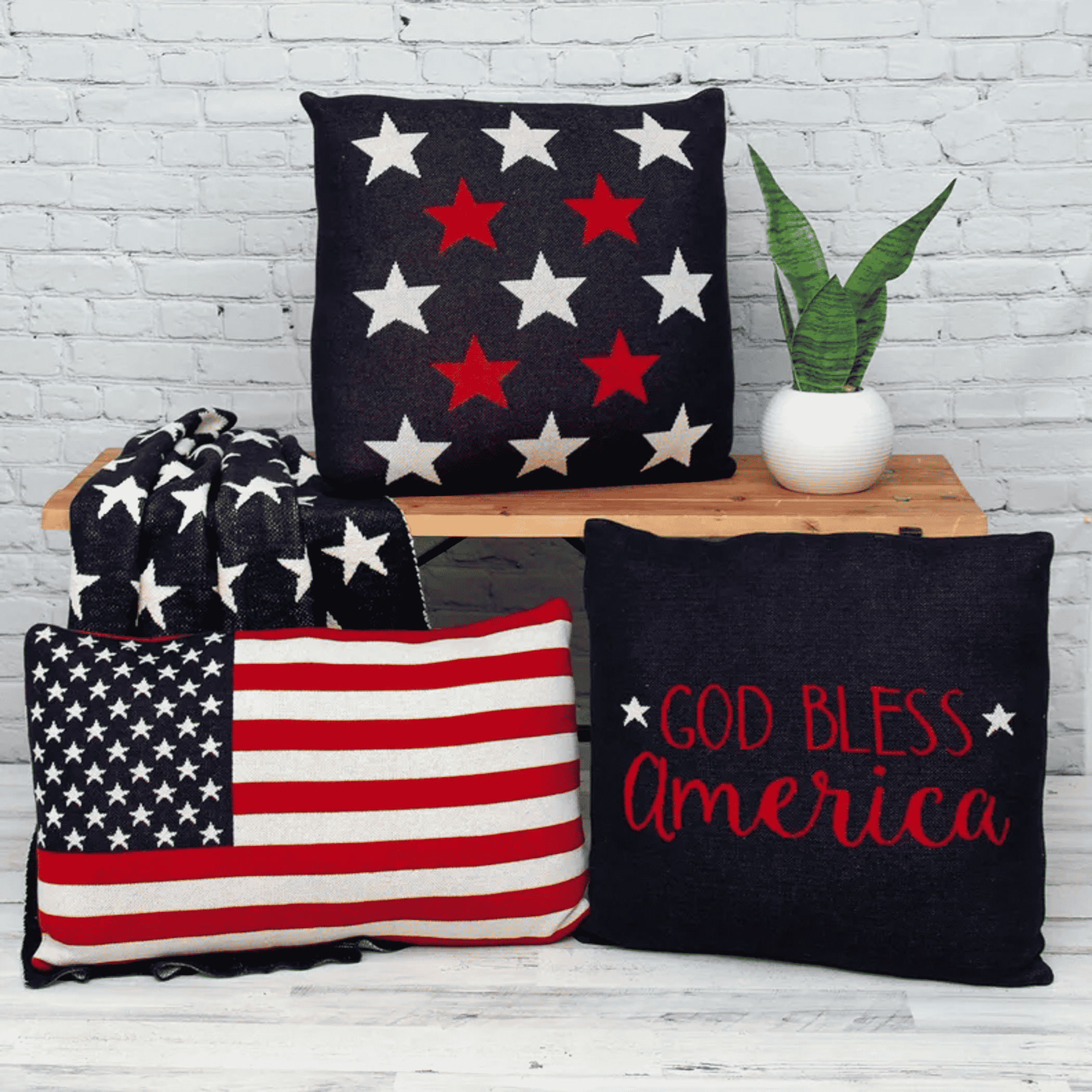 Navy throw pillows with American star designs and red “God Bless America” text