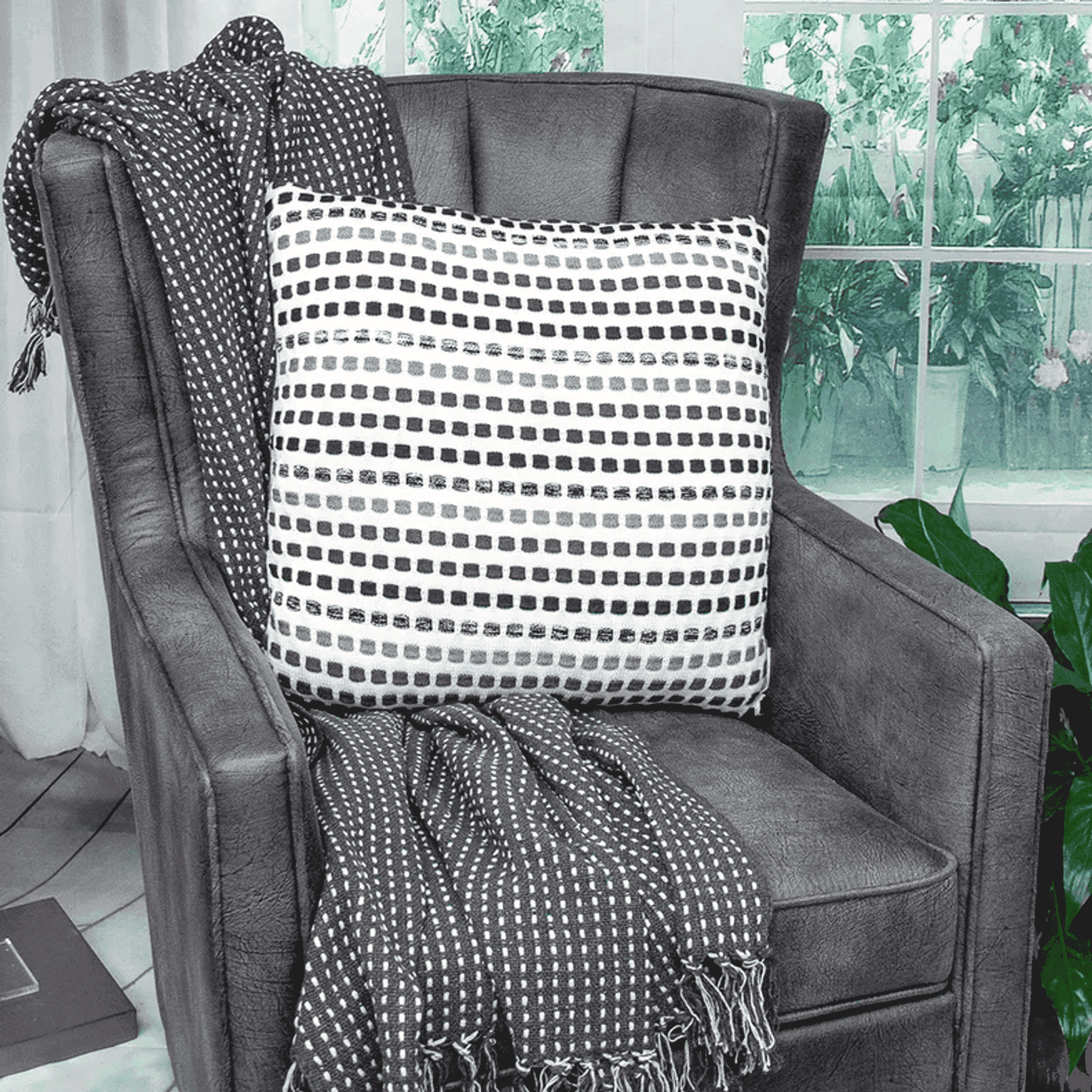 Beige patterned throw pillow with black and white horizontal dot stripes