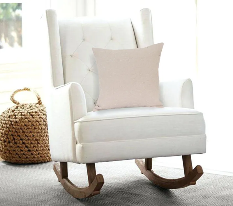 Beige square throw pillow on white chair, smooth front