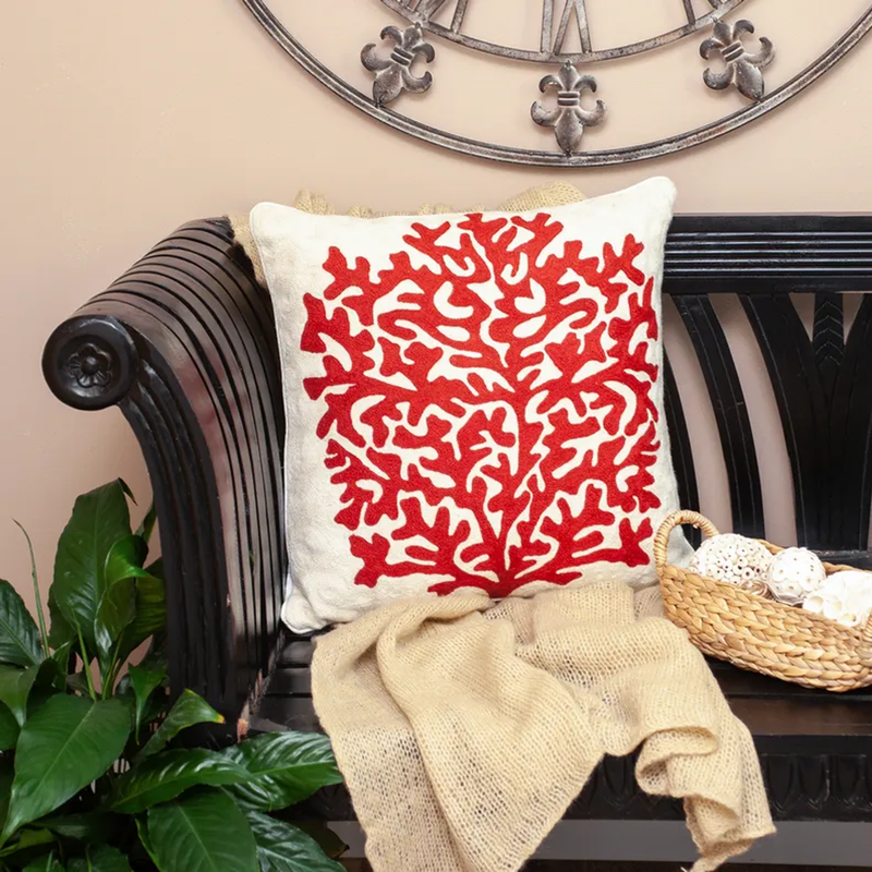 Beige pillow with red coral pattern front and woven-texture fabric