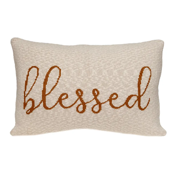 Beige throw pillow with embroidered 'Blessed' script