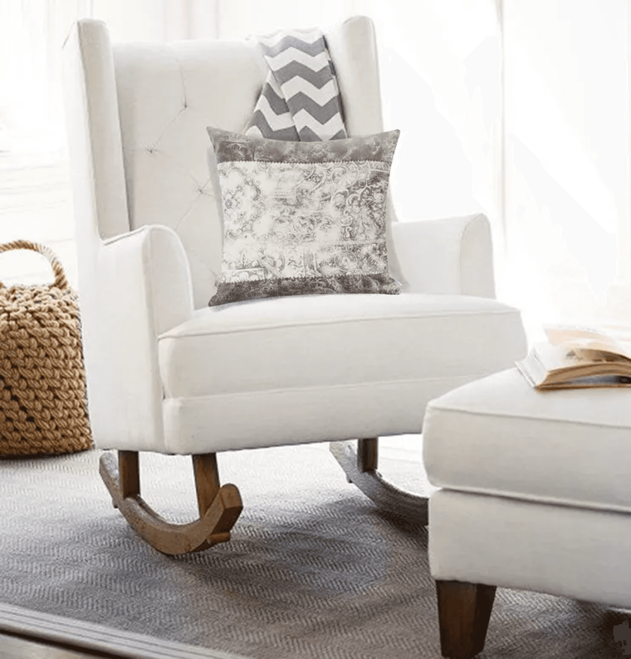 Gray patterned square throw pillow on a white armchair seat.