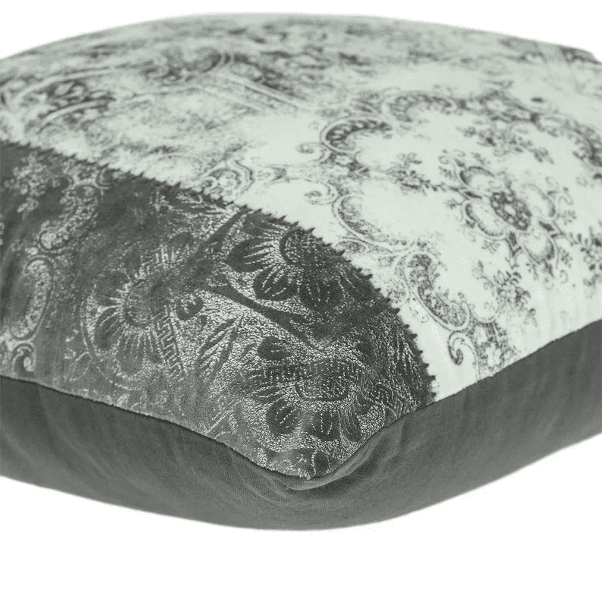 Gray ornamental print throw pillow showing stitched seam and dark fabric edge.