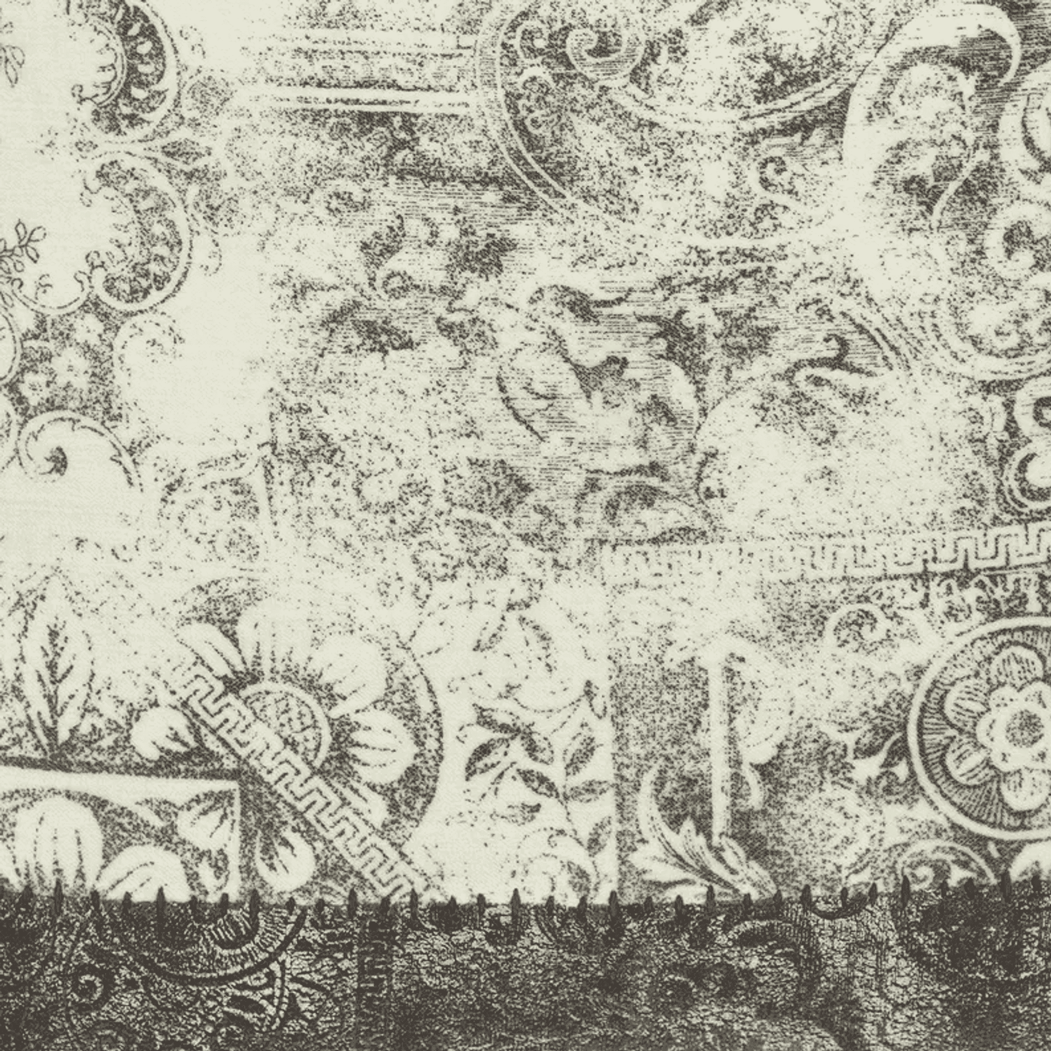 Close-up of gray and white ornate paisley throw pillow fabric pattern.