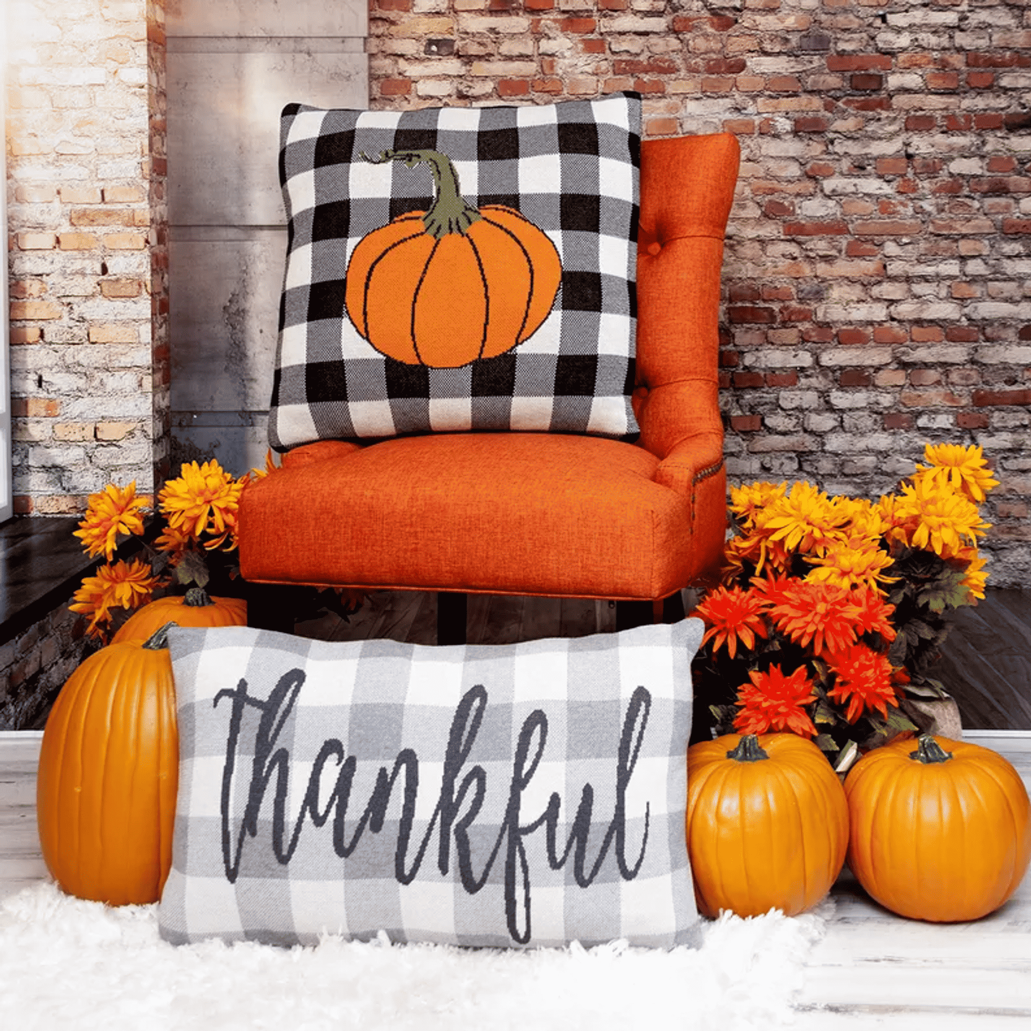 Transitional throw pillow with orange pumpkin on black-and-white buffalo check and “thankful”