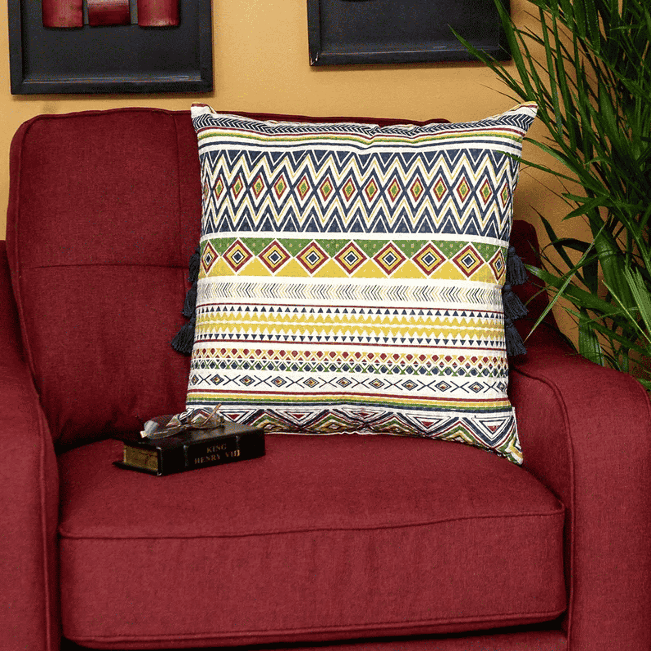 Multicolor geometric throw pillow with navy tassel fringe and striped bands