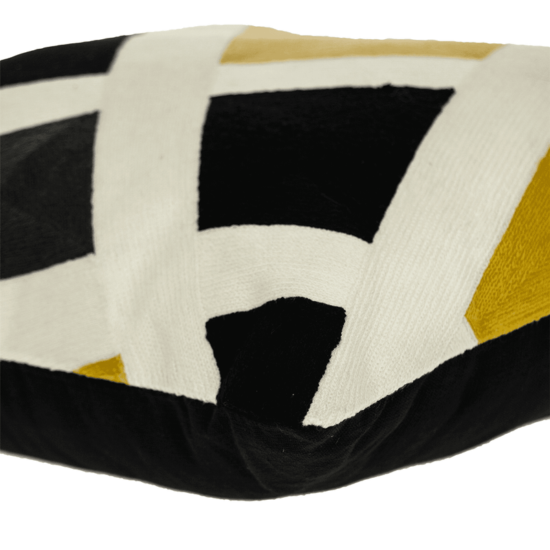 Close-up of contemporary pillow cover: white fabric with black squares and yellow X details