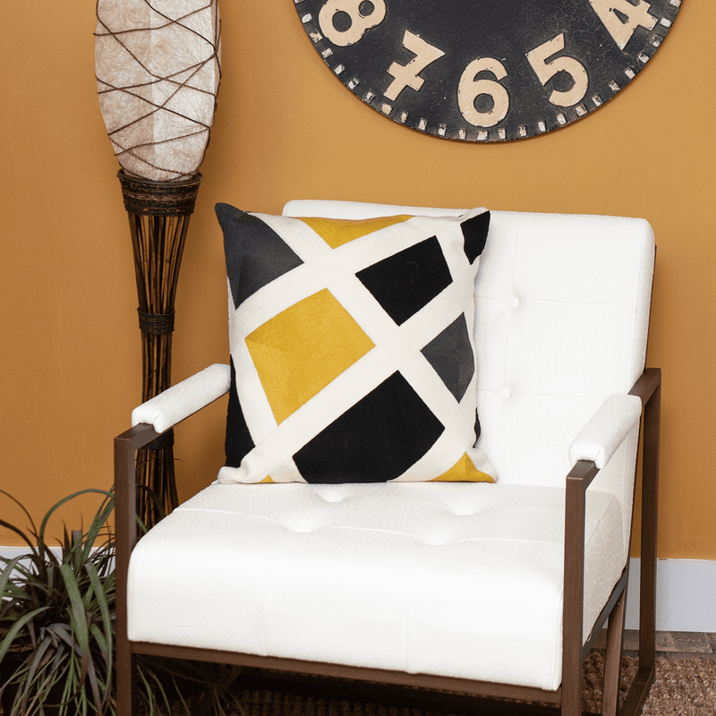 Contemporary square pillow cover with white and black geometric X design and yellow accents