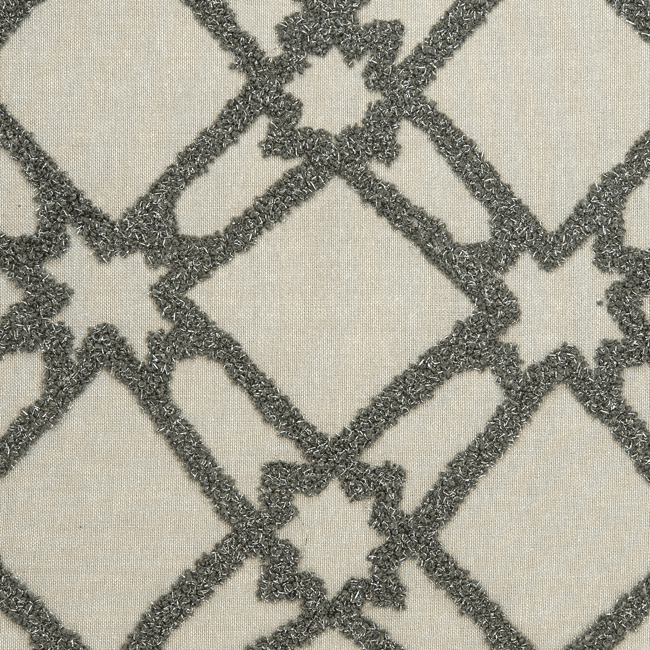 Close-up of beige throw pillow fabric with dark gray diamond lattice embroidery