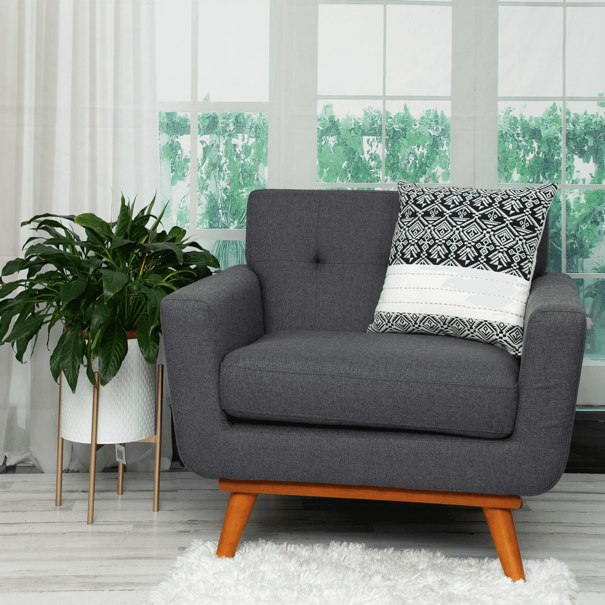 Black-and-white patterned throw pillow with white stripe section on a chair