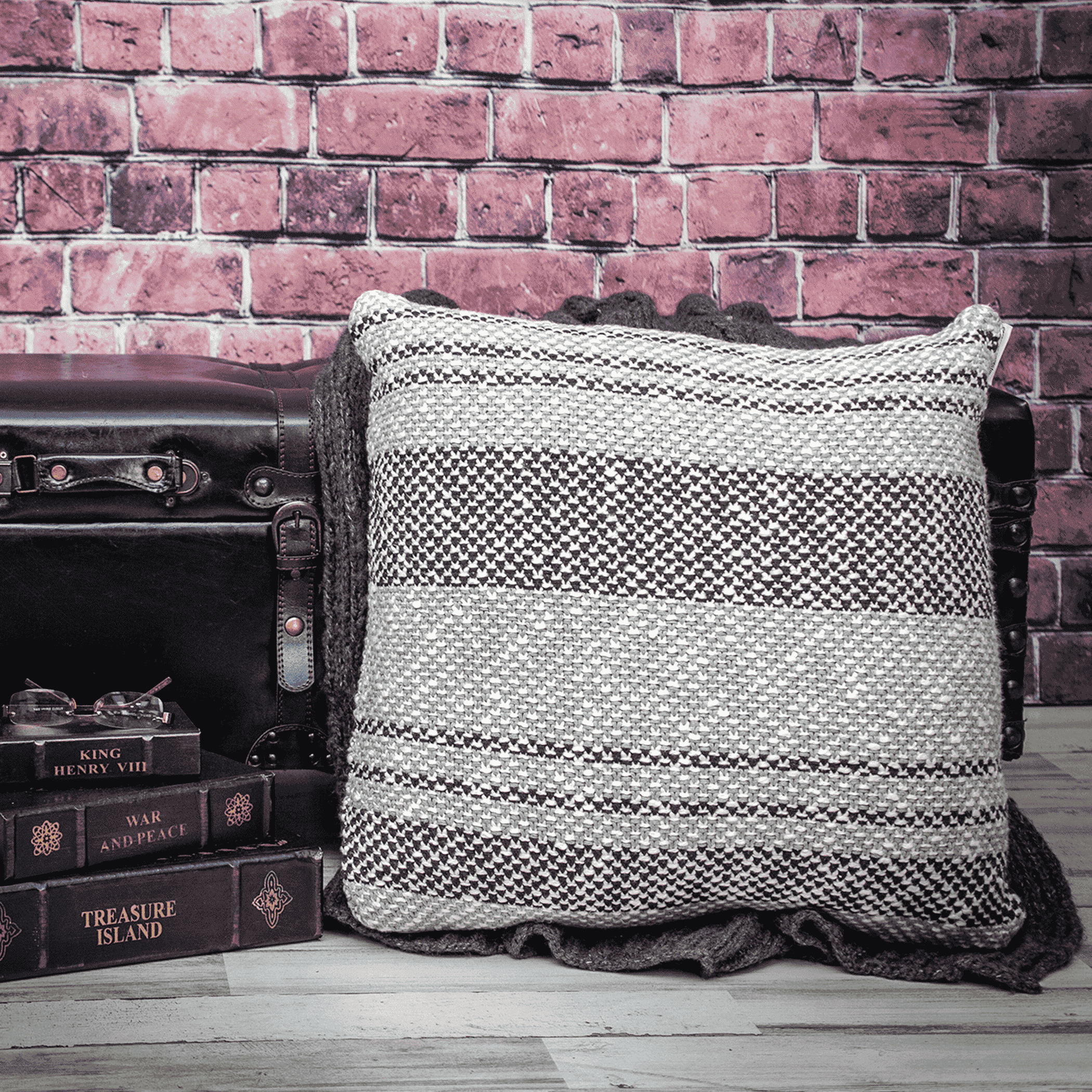Gray and black woven stripe throw pillow with stitched edge, square shape