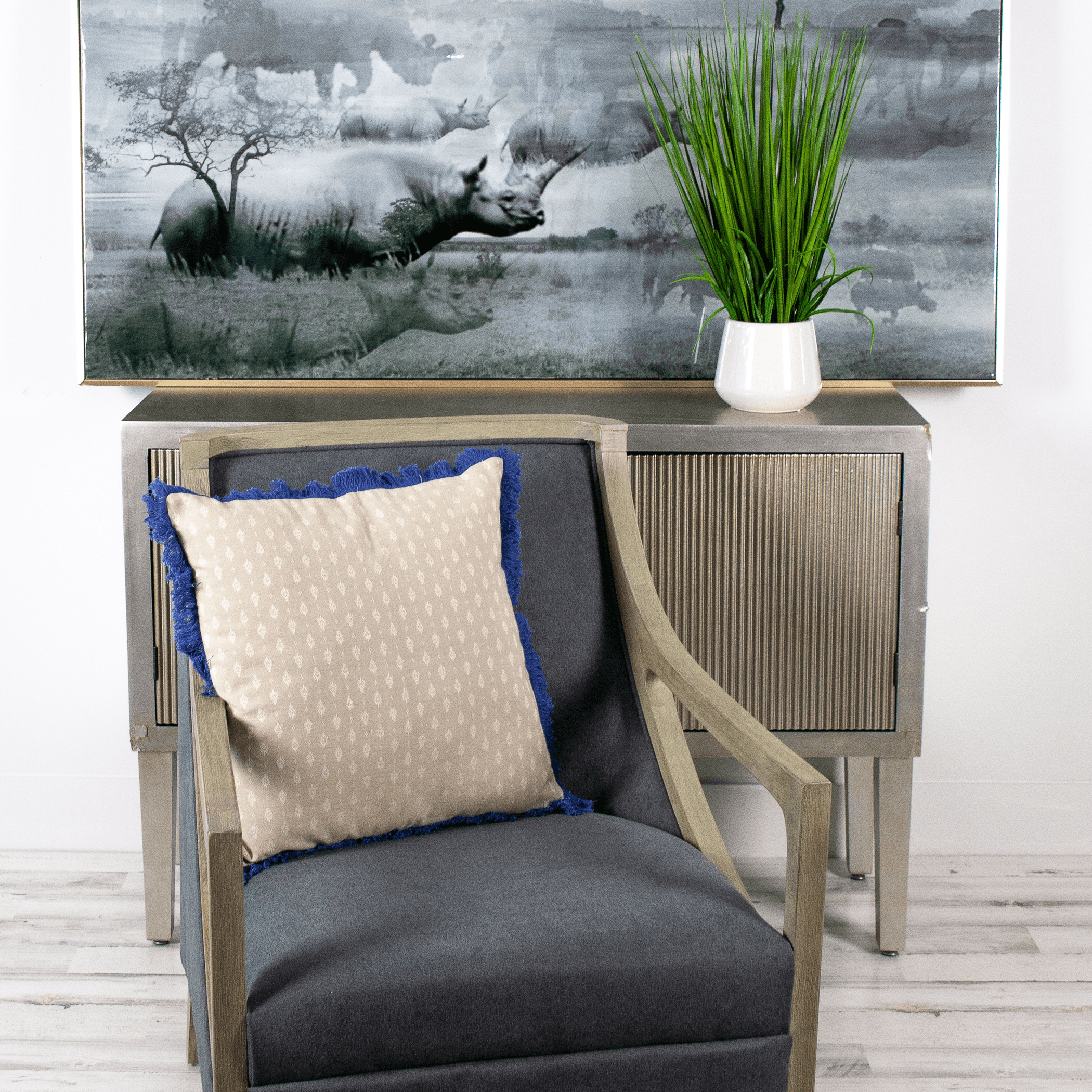 Beige knit throw pillow with small dotted texture and blue edge trim