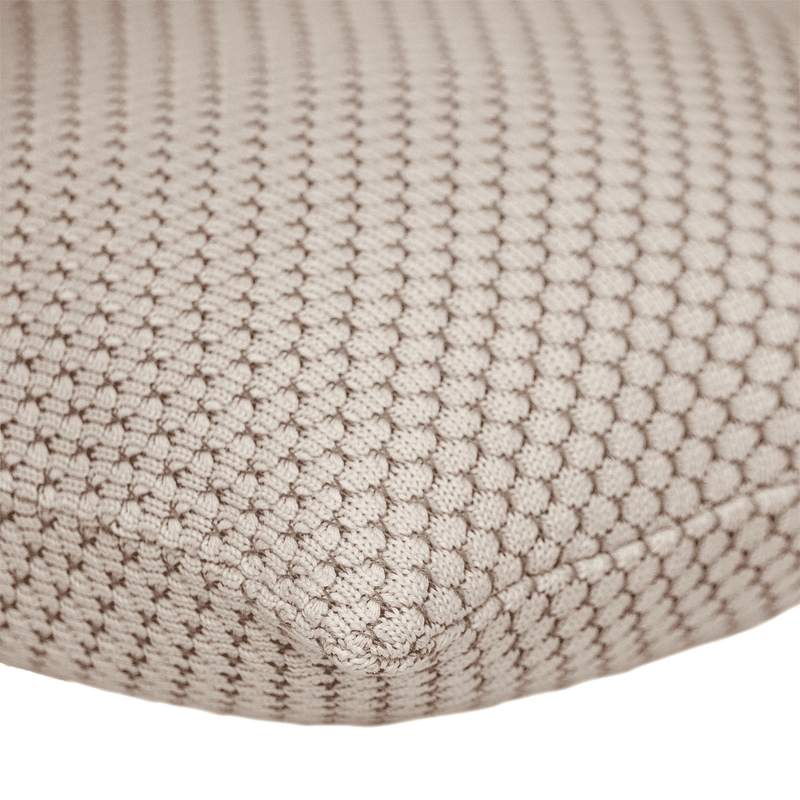 Beige knitted throw pillow fabric close-up showing textured weave