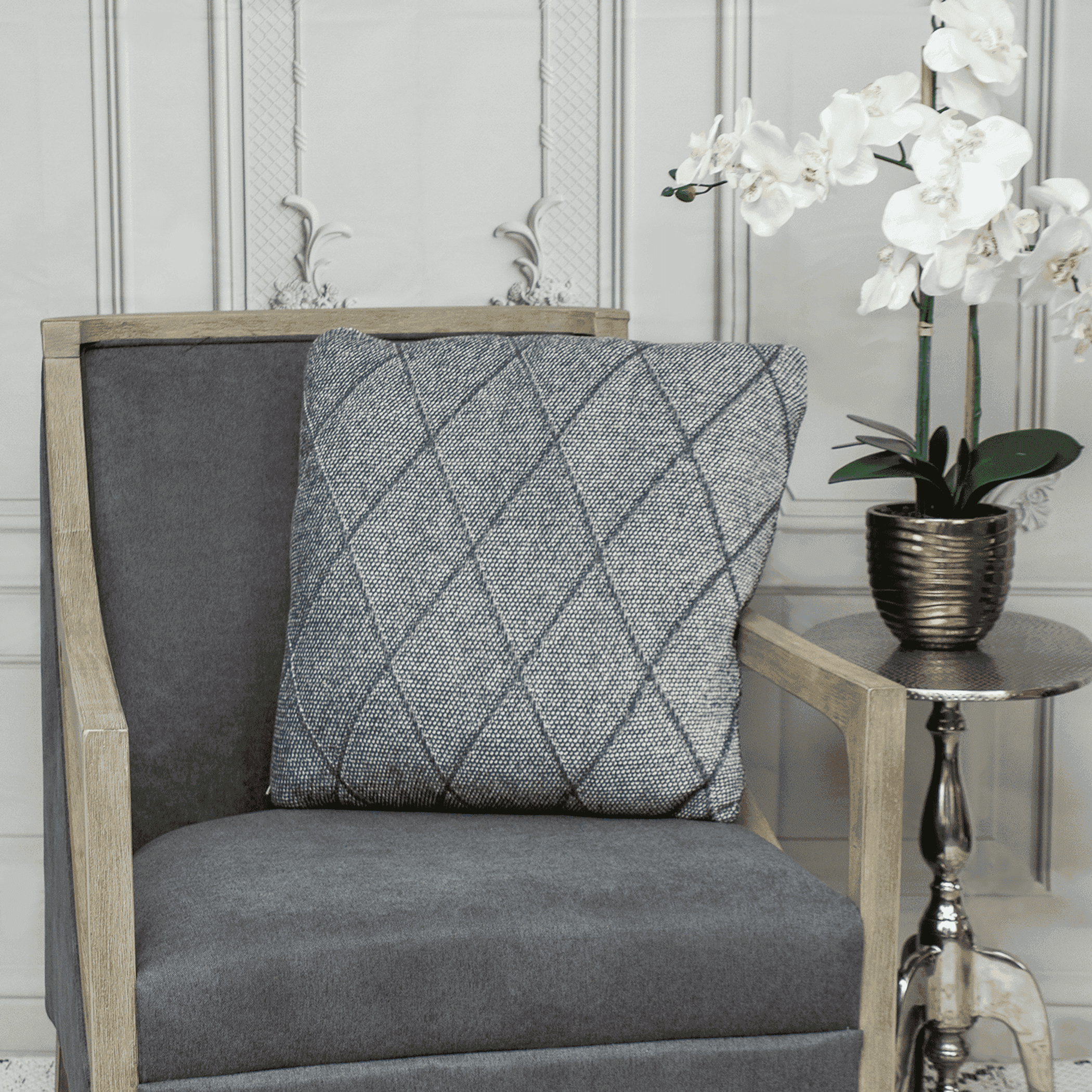Gray quilted throw pillow with diamond pattern, square shape