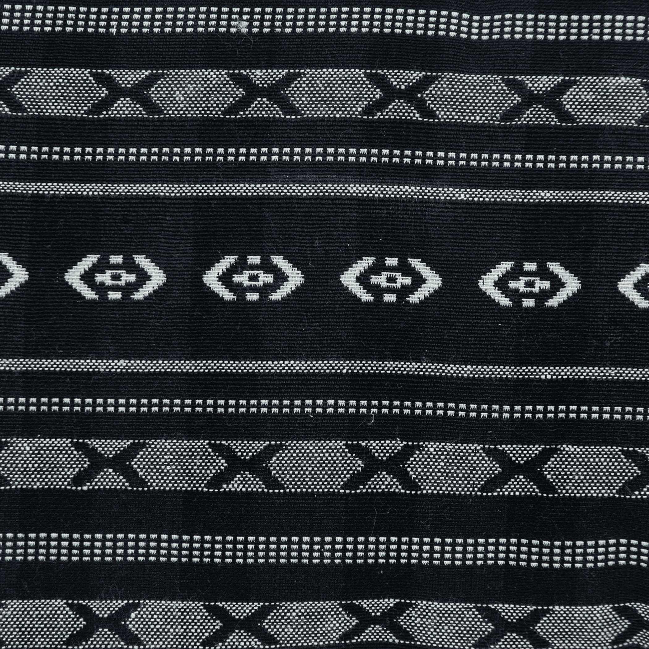 Black and gray geometric stripe throw pillow cover with repeating X and dot motifs
