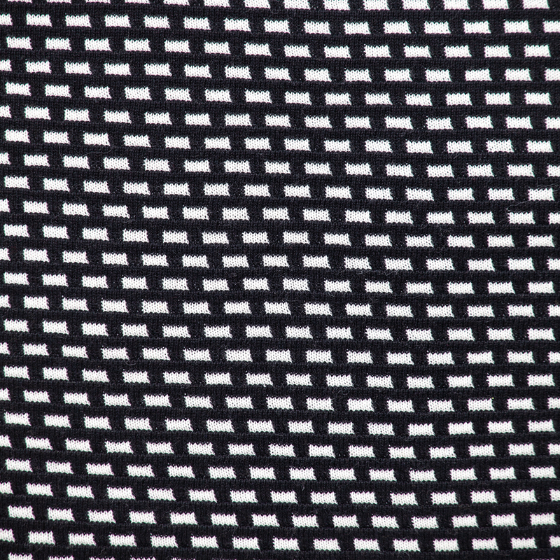 Close-up of black and white woven geometric pattern fabric for throw pillow