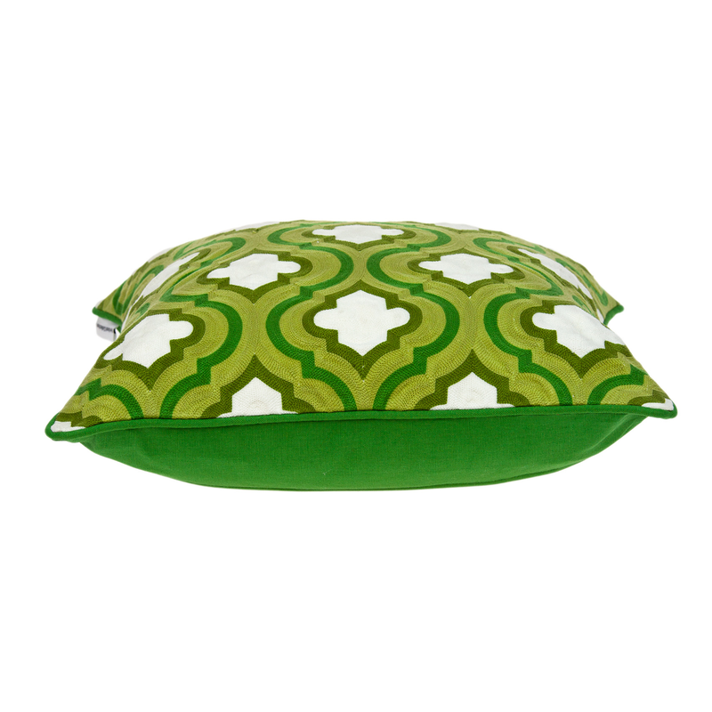 Green patterned throw pillow with white quatrefoil motifs and green side panel