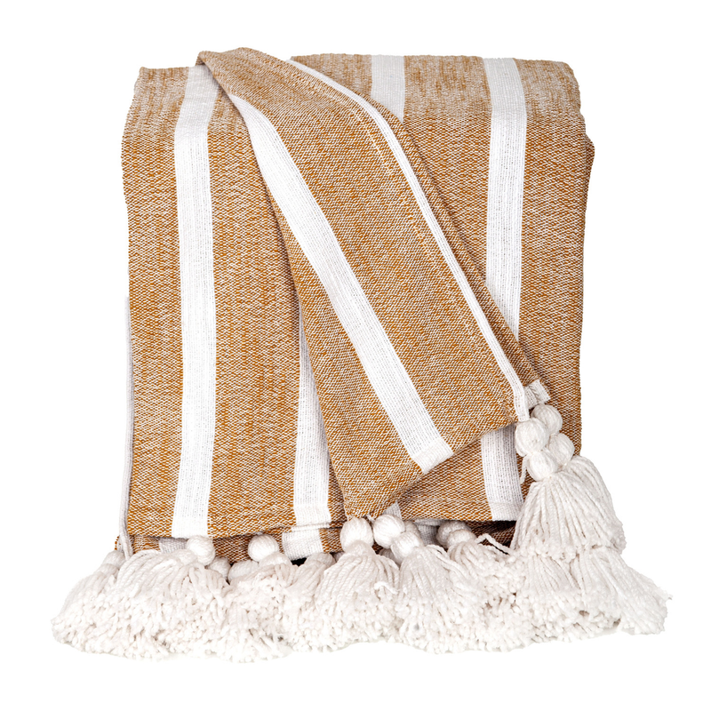 Mustard cotton throw with bold white stripes and white pom-tassel fringe, folded.