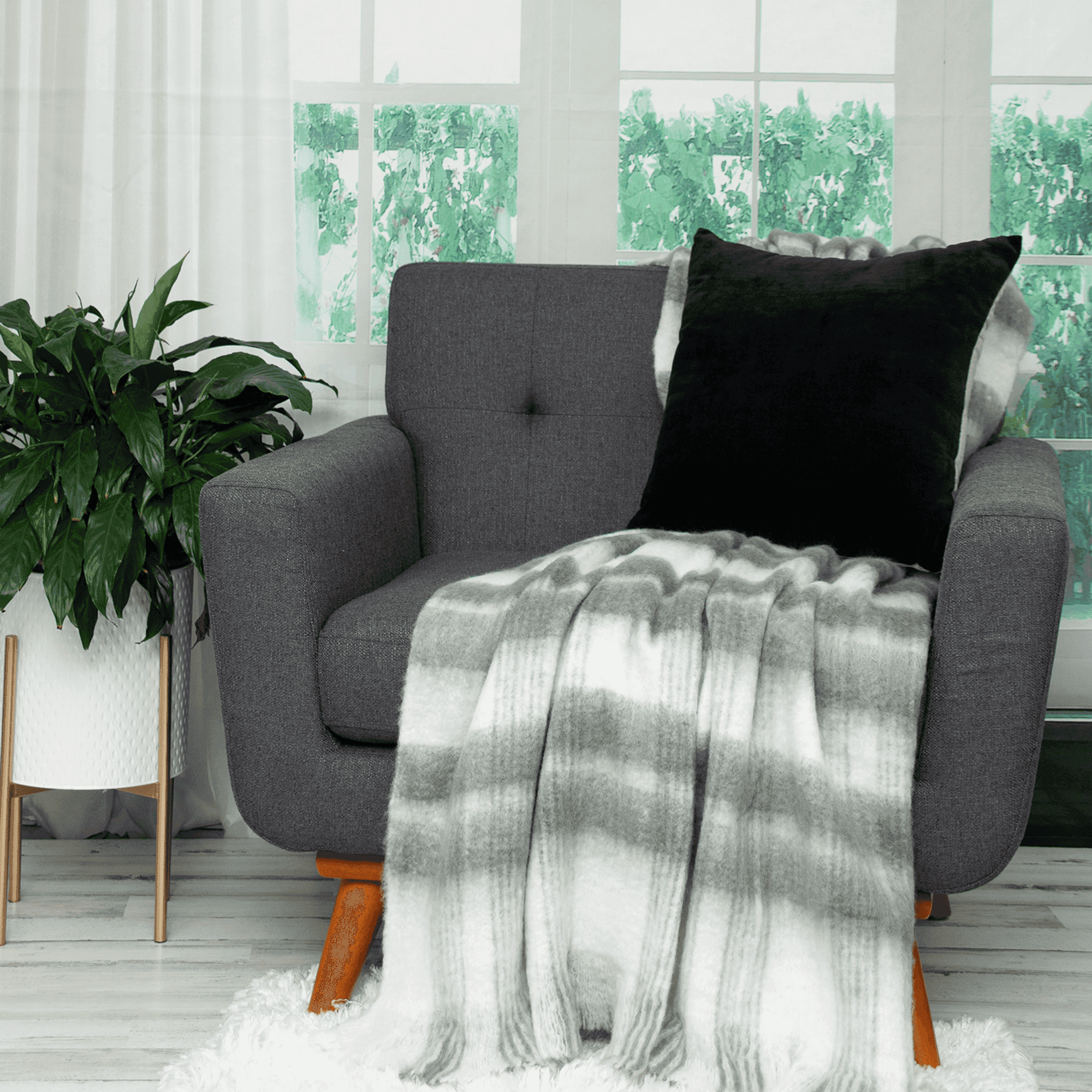 Black throw pillow on a gray sofa